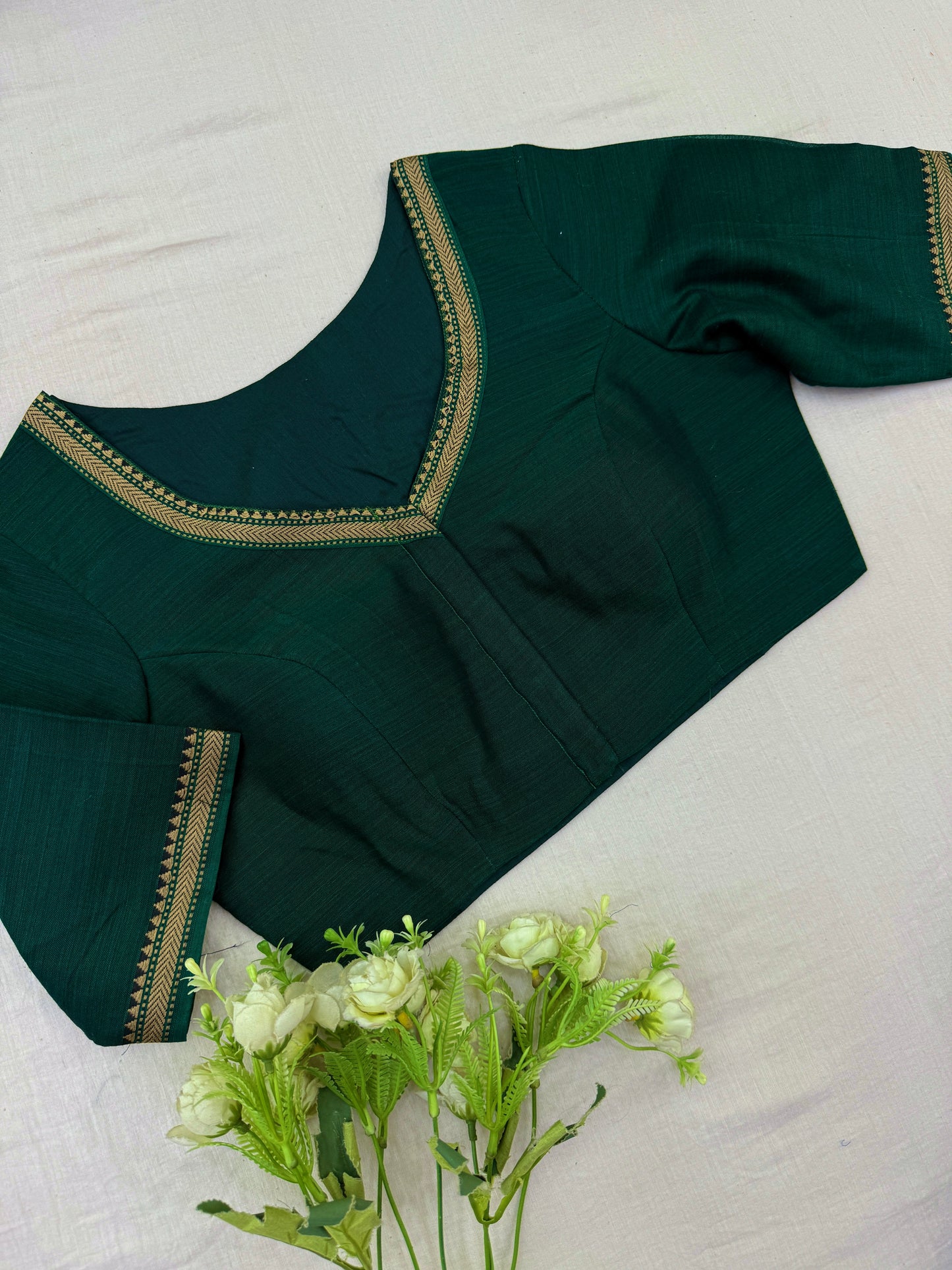 Readymade stitched blouse in emerald green with zari V-neck and sleeve detailing