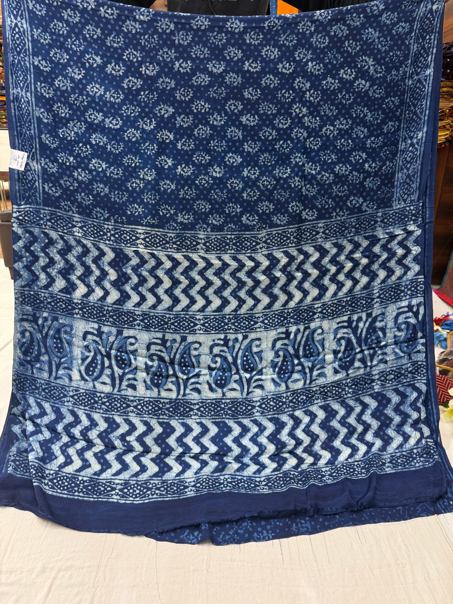 Traditional indigo blue Bagru saree with intricate floral and geometric hand-block prints.