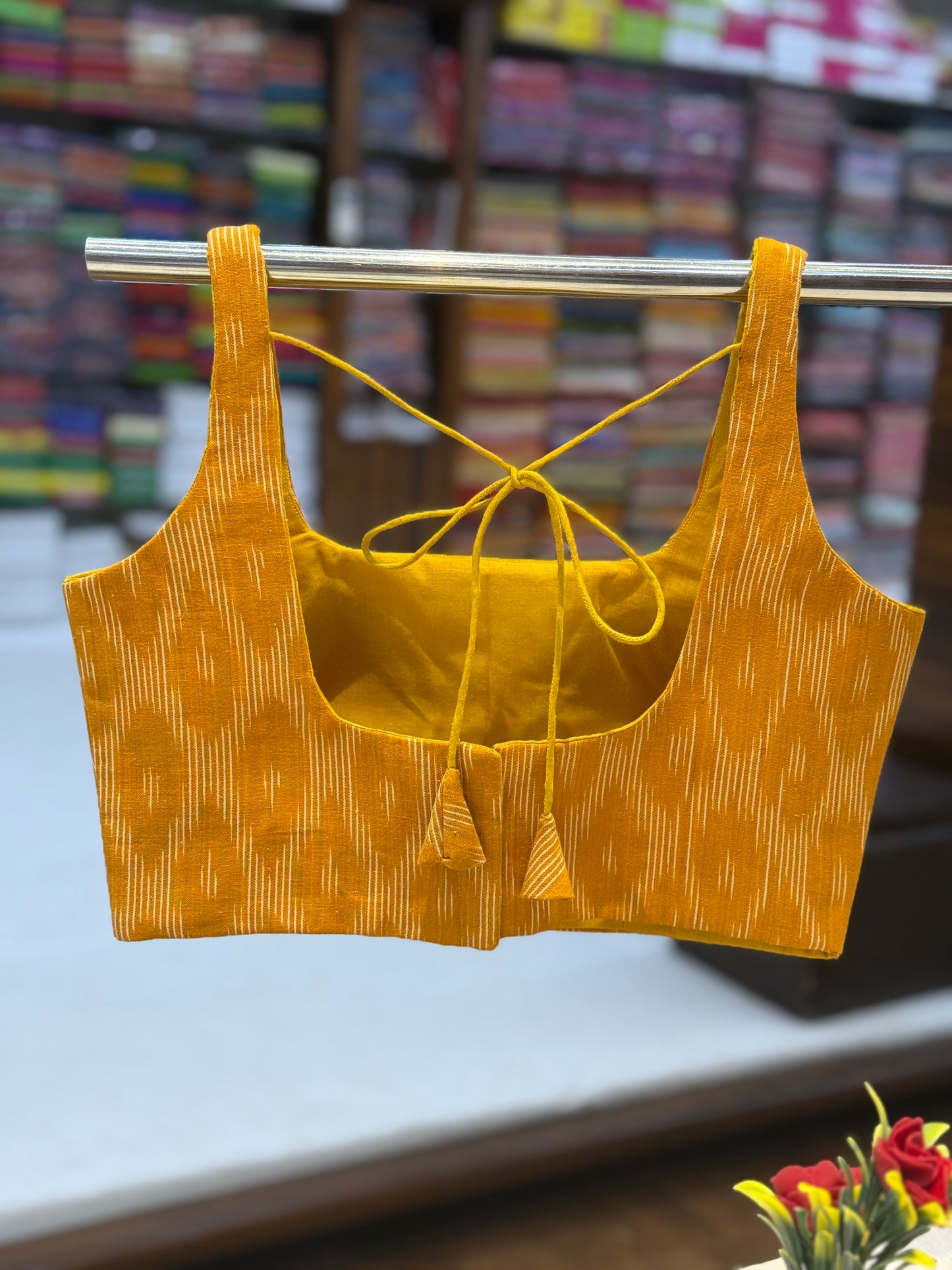 Yellow ikat padded blouse with stylish back hook closure and tie-up detail – crafted from handloom fabric with pure cotton lining.