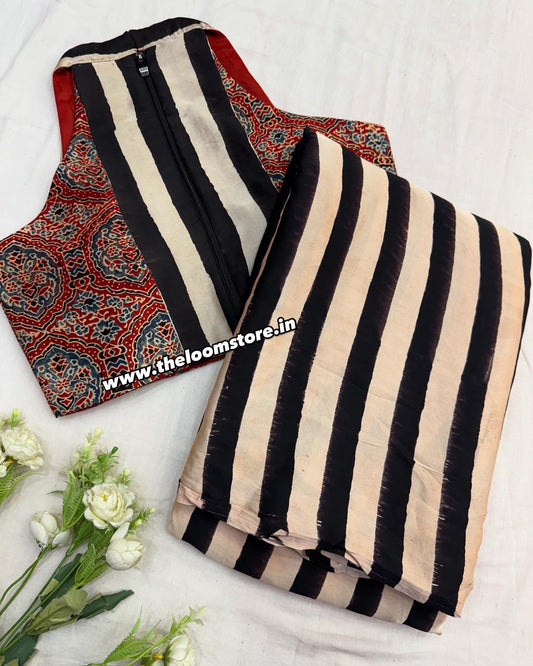 Ruhani Rust Ajrakh saree blouse set in rust red and indigo, featuring traditional circular and stripe motifs on modal silk with a sleeveless V-neck blouse